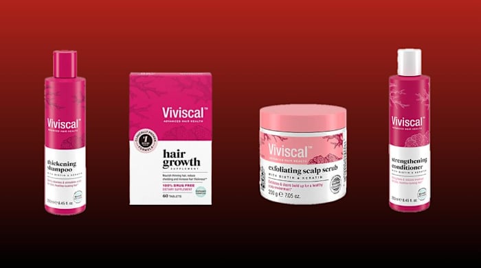 Viviscal hair growth products against a red background, including thickening shampoo, strengthening condition, exfoliating scalp scrub and hair growth supplement.
